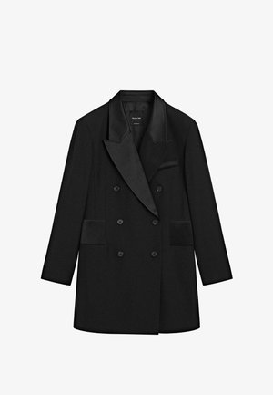 Schwarzer doppelt geknöpfter Mantel mit Satinspitzrevers, zwei Taschen vorne und sechs Knöpfen. Taillierte Passform mit glatter Textur.