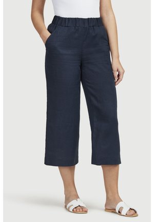 Navy blue, linen culotte pants with an elastic waistband, side pockets, and a relaxed fit, featuring a cropped length and lightweight texture.