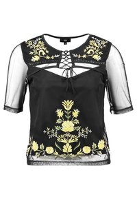 Blusa nera con maniche corte in tulle trasparente, ricami floreali in giallo e verde e dettaglio allacciato frontale.