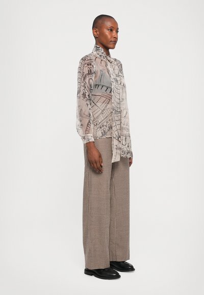 Sheer, patterned button-up shirt in beige and grey with detailed architectural prints, paired with wide-legged, houndstooth trousers.