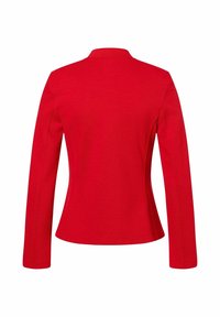 Red fitted blazer with long sleeves, a rounded collar, and textured fabric. Features subtle side seams for shaping.