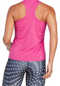 Top de tirantes ajustado en rosa brillante, combinado con leggings de patrón en blanco y negro con diseños geométricos, textura suave.