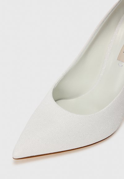 White pointed-toe pump with a textured upper, featuring a subtle sparkle, and a light-colored interior. Smooth, tapered design with minimal accents.