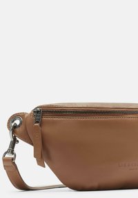 Borsa in pelle marrone a vita con chiusura zippata e fermo metallico su una tracolla regolabile, che mostra la stampa del marchio sul davanti.