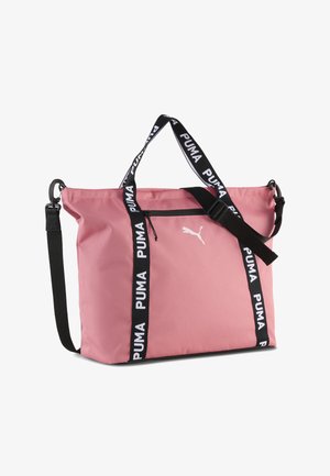 Pink Puma tote-taske med sort justerbar skulderrem og sorte håndtag med mærke, forreste lynlåslomme og hvid Puma-logo.