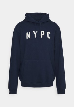 Navy blue hoodie made of soft fabric, featuring a kangaroo pocket and white embroidered "NYPC" lettering on the chest. Adjustable drawstring hood.