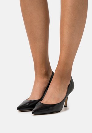 Black leather high-heeled pumps with pointed toes and a smooth texture. Features a low-cut design and slender gold-tone stiletto heels.