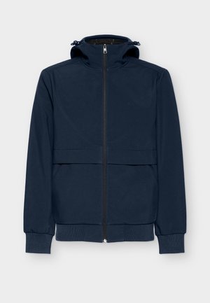 Tamsiai mėlyna trumpa striukė su gobtuvu, turinti visą priekinį užtrauktuką, dvi priekinės kišenes, raukšlių rankogalius ir lygią, lengvos medžiagos apdailą.