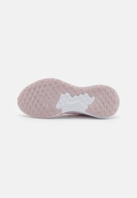 Nike shoe sole with a textured pink rubber outsole and white midsole. Features circular traction patterns and a logo detail in white.