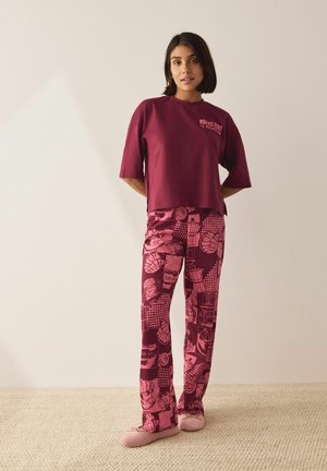 Burgundy cotton t-shirt with short sleeves, paired with patterned burgundy and pink pants featuring illustrations of food items.