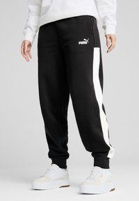 Puma - AROUND THE BLOCK  - Spodnji deli trenirk - black Miniaturna slika 1