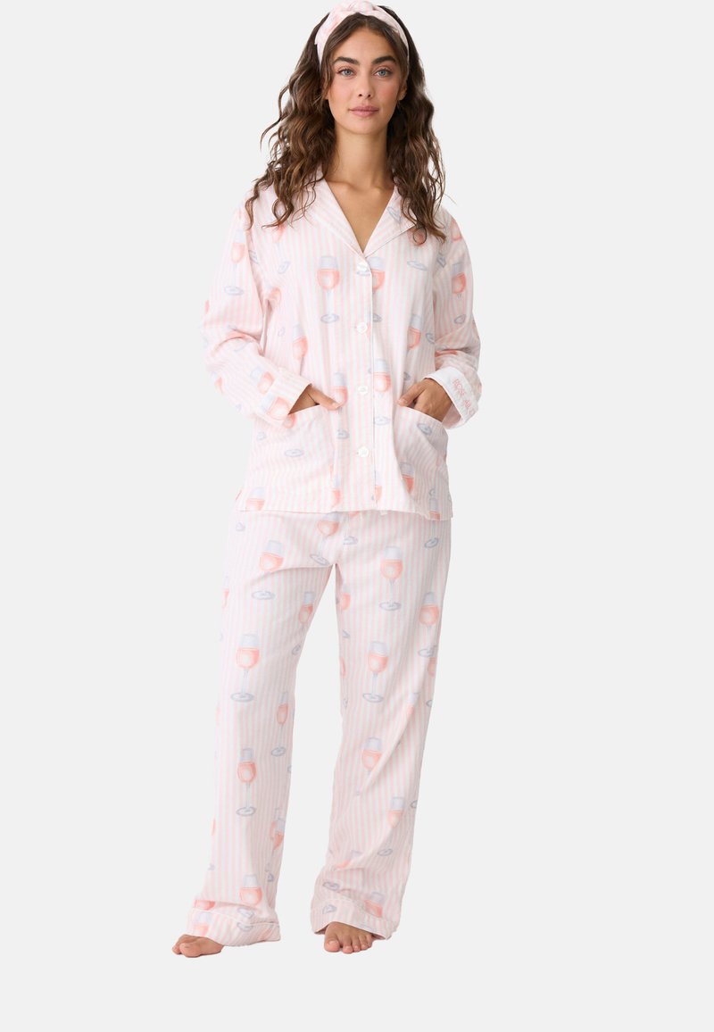 Gestreiftes Schlafanzug-Set in Pink und Weiß, bestehend aus einem geknöpften Oberteil mit Taschen und passenden Hosen, verziert mit Mustern von Weingläsern und Lippen.