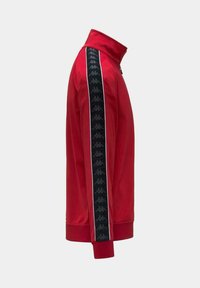 Giacca sportiva rossa con collo alto, dotata di strisce nere laterali decorate con un motivo di logo e piping bianco lungo i bordi.