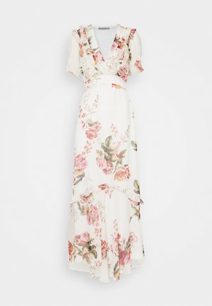 Robe portefeuille blanche à motifs floraux roses et verts, manches courtes bouffantes, décolleté en V à volants et ourlet asymétrique superposé.