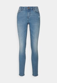 Jeans skinnies azul claro, material de denim, cintura de media altura, diseño de cinco bolsillos, ligero desvanecimiento y parches desgastados, silueta ajustada.