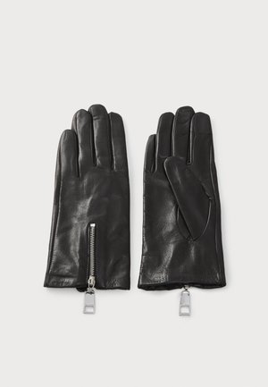 Guantes de cuero negro con un acento de cremallera y un diseño con pulgar abierto. Textura suave con detalles de costura visibles.