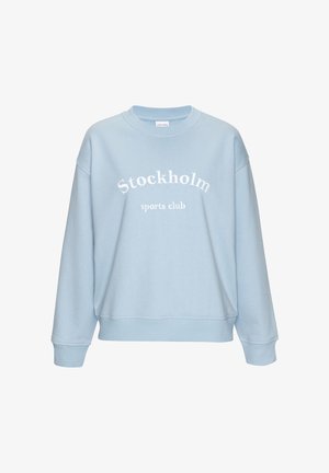 Light blue crewneck sweatshirt with "Stockholm sports club" white text centered on the front, featuring ribbed cuffs and hem.
