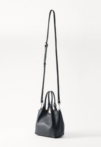Black pebbled leather handbag with two top handles and a detachable long strap, featuring a structured shape and smooth finish.