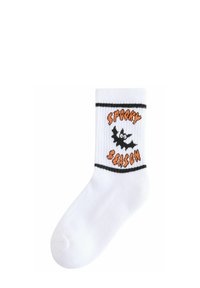White cotton sock featuring black and orange stitching. Displayed text reads "Spooky Season" with a bat graphic. Ribbed cuff with black stripes.