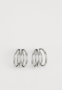 Silver-toned earrings featuring four interlocking circular hoops. Smooth surface with a polished finish, creating a shiny appearance.