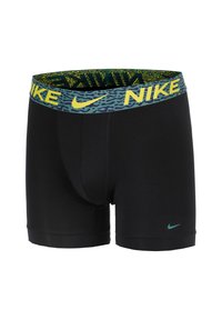 Boxers atléticos negros con una cinturilla estampada en verde y amarillo que presenta el logotipo de "Nike". Tejido suave con un diseño ajustado y un pequeño logotipo en la pierna.
