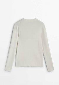Long-sleeve light beige ribbed top featuring a rounded neckline and straight cut. Textured fabric with visible seam details.