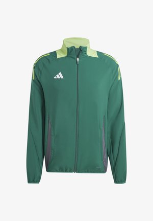 Grüne Sportjacke aus glattem Stoff, mit durchgehendem Reißverschluss, hellgrünen Akzenten und grauen Seitenteilen. Enthält ein weißes Logo auf der Brust.