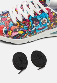 Multicolored sneaker with intricate patterns featuring cartoonish designs; white laces; includes two black shoelaces coiled below.