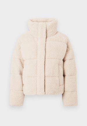Beige flanellist puffer-jakk, millel on kõrge krae, millel on tikitud disain ja ees olevad taskud, pehme tekstuur kogu ulatuses.