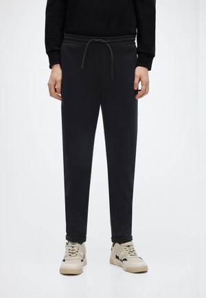 TAPERED JERSEY PANTS - Püksid - black