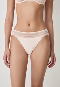 Light pink underwear with a smooth fabric, featuring a lace band at the waist and delicate trim along the edges.