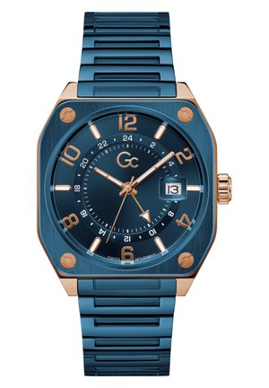 Orologio in acciaio inossidabile blu con cassa ottagonale, accenti in oro rosa e quadrante testurizzato. Tra le caratteristiche ci sono una finestra della data e numeri in grassetto.