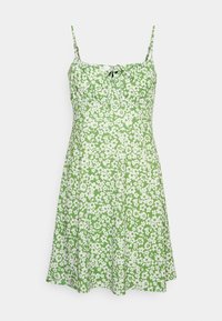 Zielona sukienka w kwiaty z białymi wzorami, regulowanymi ramiączkami na sznurek oraz dopasowaną górą i rozkloszowanym dołem. Wykonana z lekkiego materiału.