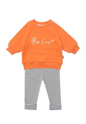 Orange sweatshirt with "Boo Crew" text and spiderweb graphic; paired with gray and white striped leggings; soft cotton fabric.