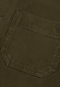 Dark olive green corduroy fabric showing a close-up of a pocket with visible ribbed texture and straight stitching along the edges.