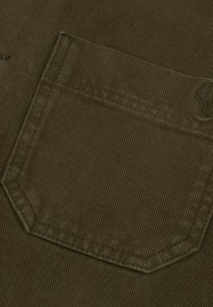 Dark olive green corduroy fabric showing a close-up of a pocket with visible ribbed texture and straight stitching along the edges.