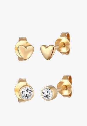 Zlaté náušnice s kamienkami vo dvoch dizajnoch: srdiečkový tvar a okrúhly tvar s priehľadnými kryštálmi, obidva s hladkými textúrami a bezpečnými zámkami.