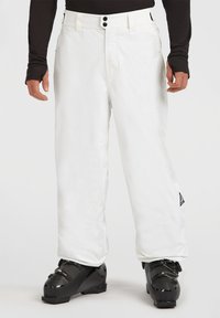 Pantalones de esquí blancos hechos de material impermeable, con un corte relajado, cierre de botón y un pequeño parche de logo en la parte inferior de la pierna.