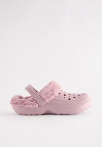 Light pink slip-on clog with ventilation holes, a soft fluffy lining, and an adjustable heel strap.