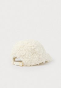 White, fluffy hat made of textured material with a rounded shape; features a gold-colored metal hardware buckle and an adjustable strap.