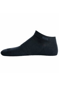 Calcetín negro hasta el tobillo hecho de una tela suave con un puño acanalado. Presenta un sutil logo en el lateral y un diseño de punta sin costuras.