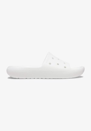 White slip-on sandal with multiple ventilation holes and a textured sole for grip, designed for casual or water use.