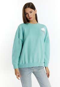 Mintgroene sweatshirt van katoen, met een ronde hals, verlaagde schouders en geborduurd wolkje op de borst.