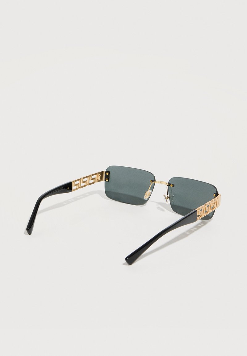 Rectangular sunglasses with dark lenses, gold geometric patterned metal temples, and glossy black plastic earpieces.