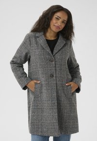 Grau karierten Mantel mit strukturiertem Design, ausgestattet mit zwei Knöpfen, großen seitlichen Taschen und einem Reverskragen, aus strukturiertem Stoff.