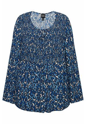 Blouse à manches longues à motifs bleus avec un col rond, un tissu froncé au niveau du buste et un détail de nœud au col.