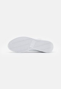 Suola di scarpa atletica bianca, strutturata con un motivo a zigzag e logo centrale. Bordi lisci, materiale in gomma resistente, design minimale.