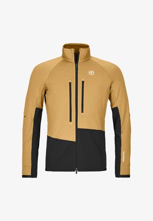 Hellbraune und schwarze Jacke mit durchgehendem Reißverschluss und Stehkragen, zwei vertikalen Reißverschlusstaschen auf der Brust sowie schwarzen Einsätzen vorne unten und an den Ärmeln.