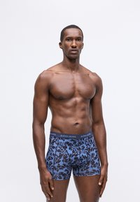 Men's boxer briefs in blue with a floral pattern, made of soft fabric. Features a branded waistband for comfort and fit.