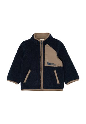 Casaco de fleece azul-marinho com contorno castanho claro, fecho de correr, dois bolsos frontais e um remendo castanho claro no peito com o texto "Since Forever".